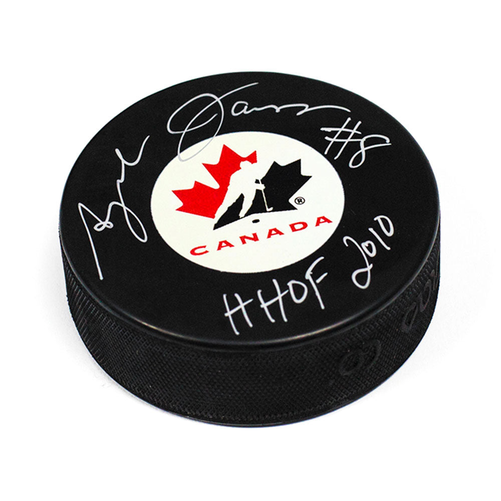Angela James Team Canada Autographed Hockey Puck with HOF 2010 Inscription | AJ Sports.